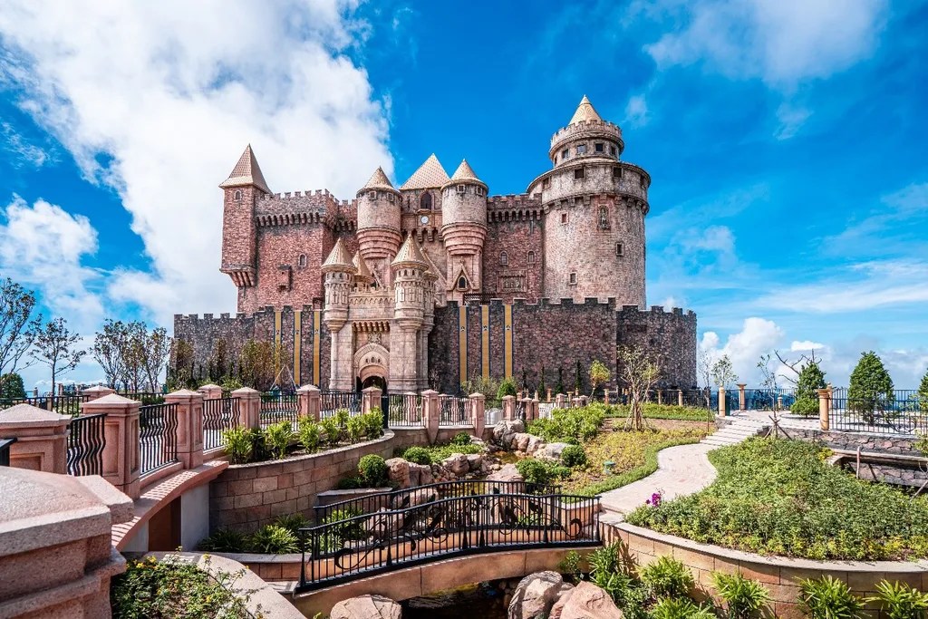 a stone castle next to a brick building