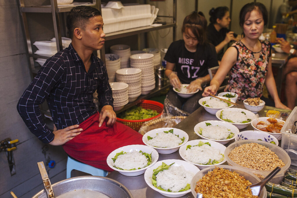a group of people sitting at a table with a plate of food