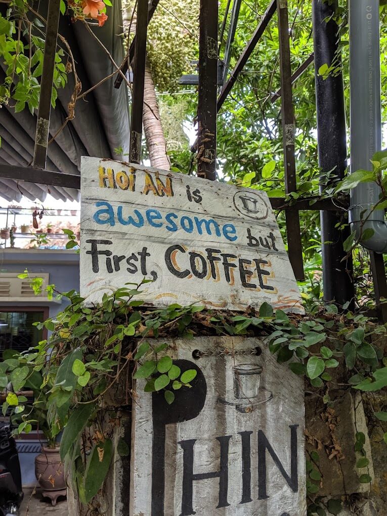 a sign hanging off the side of a building