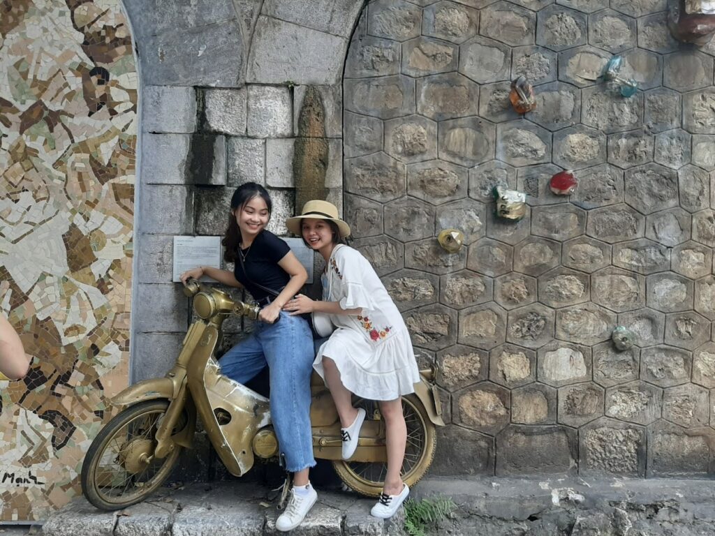 a person sitting in front of a brick building
