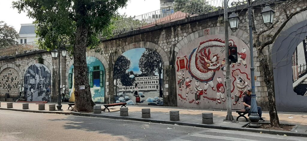 a building with graffiti on the side of a road