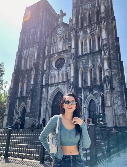 a woman standing in front of a church