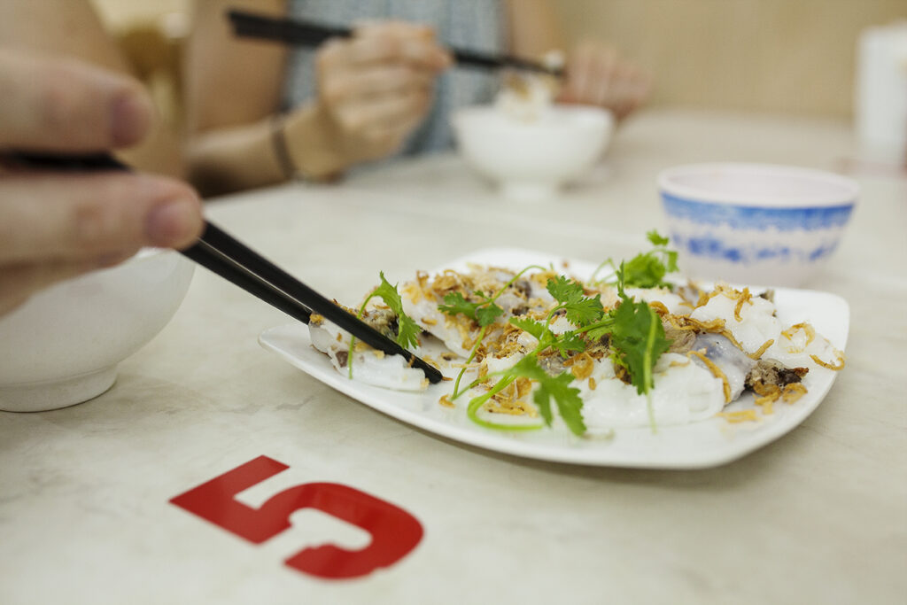a person sitting at a table with a plate of food