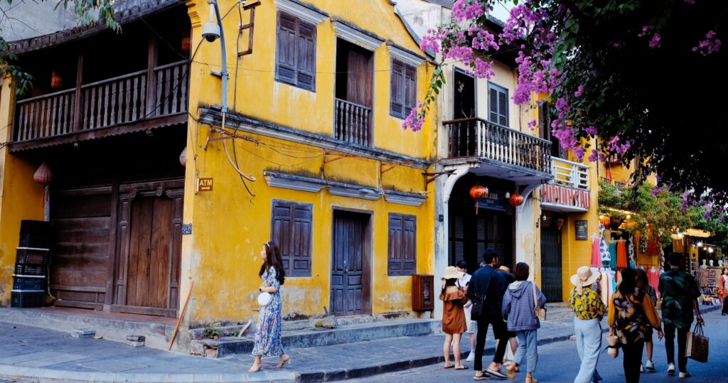 a person walking down a street in front of a building