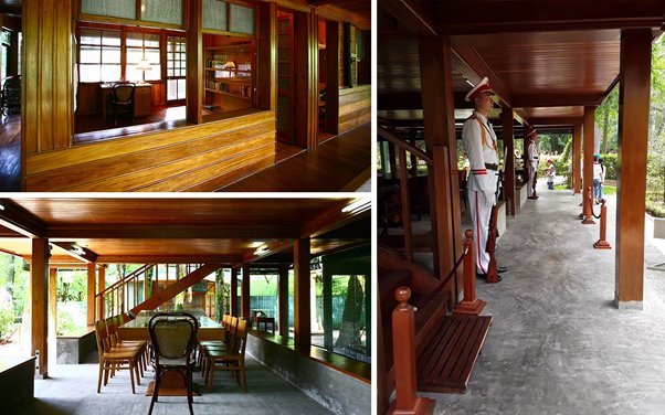 Wooden interior with chairs and table, military mannequins on exterior covered walkway.