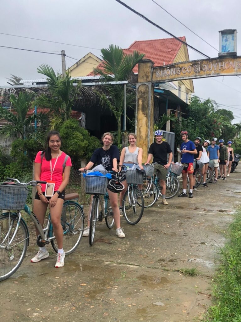 a group of people riding on the back of a bicycle