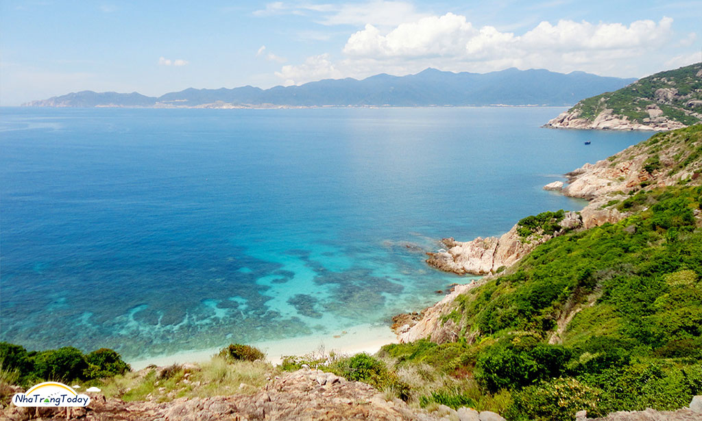 a large body of water with a mountain in the background