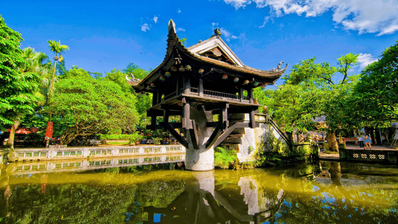 a castle with a clock at the top of a body of water