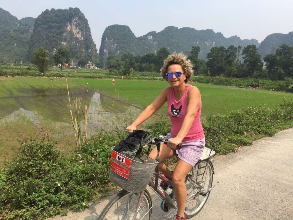 a person riding a bike down a dirt road
