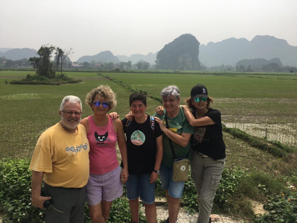 a group of people standing in front of a mountain