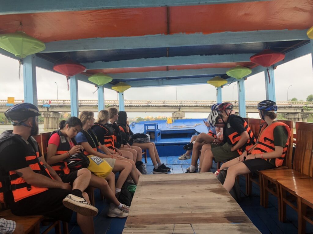 a group of people sitting at a dock