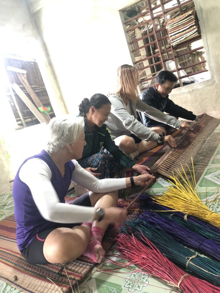 a group of people sitting at a table using a laptop