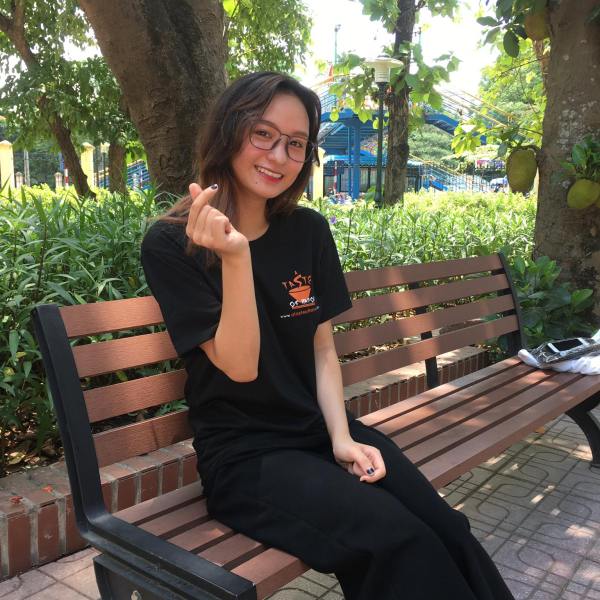 a woman sitting on a wooden bench
