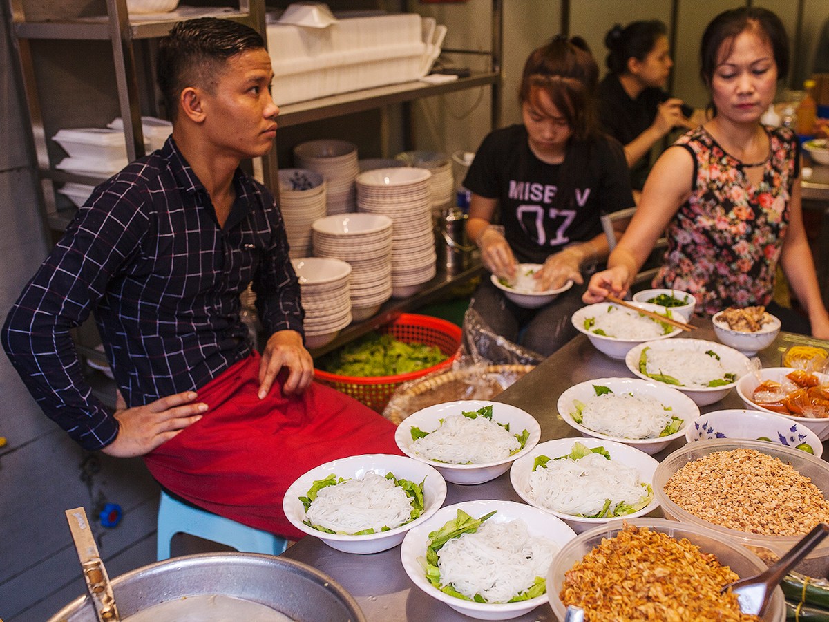 a group of people sitting at a table with a plate of food