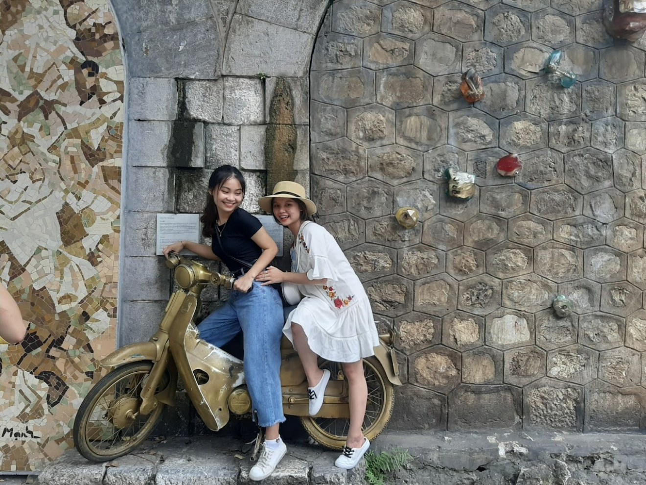 a person sitting in front of a brick building