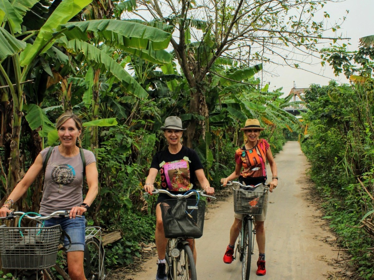 a group of people riding on the back of a bicycle