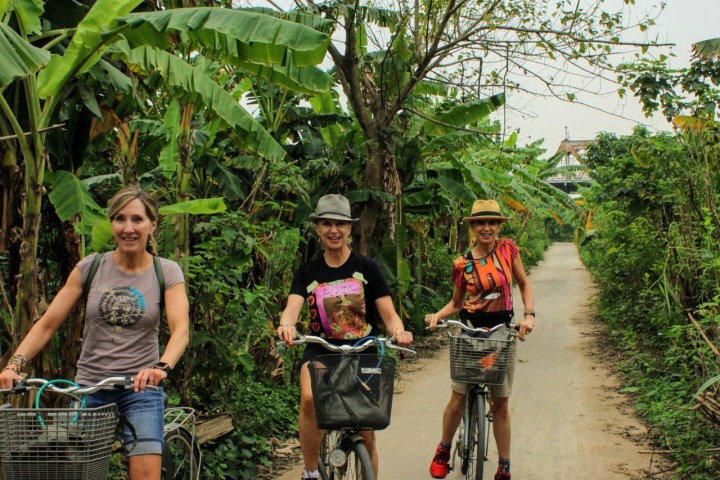a group of people riding on the back of a bicycle