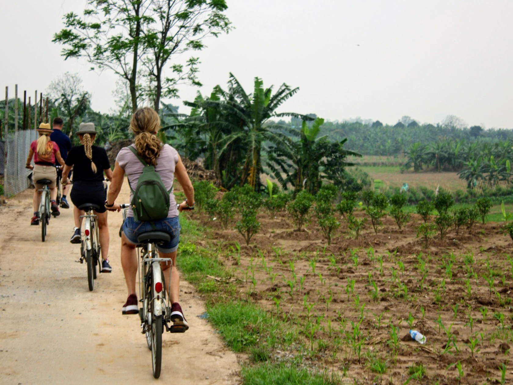 a person riding a bike down a dirt road