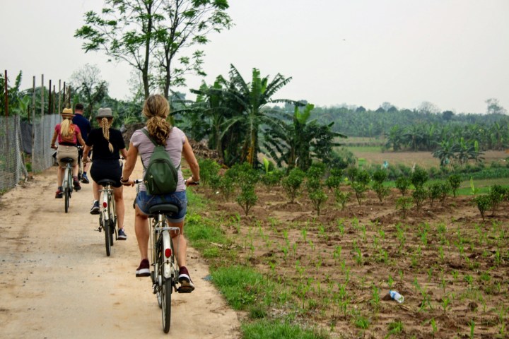 a person riding a bike down a dirt road