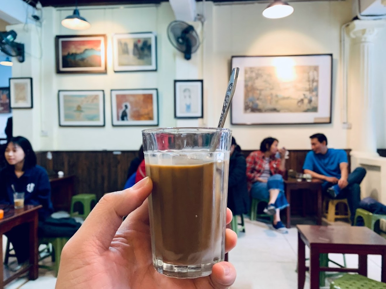 a person sitting at a table with a glass of wine