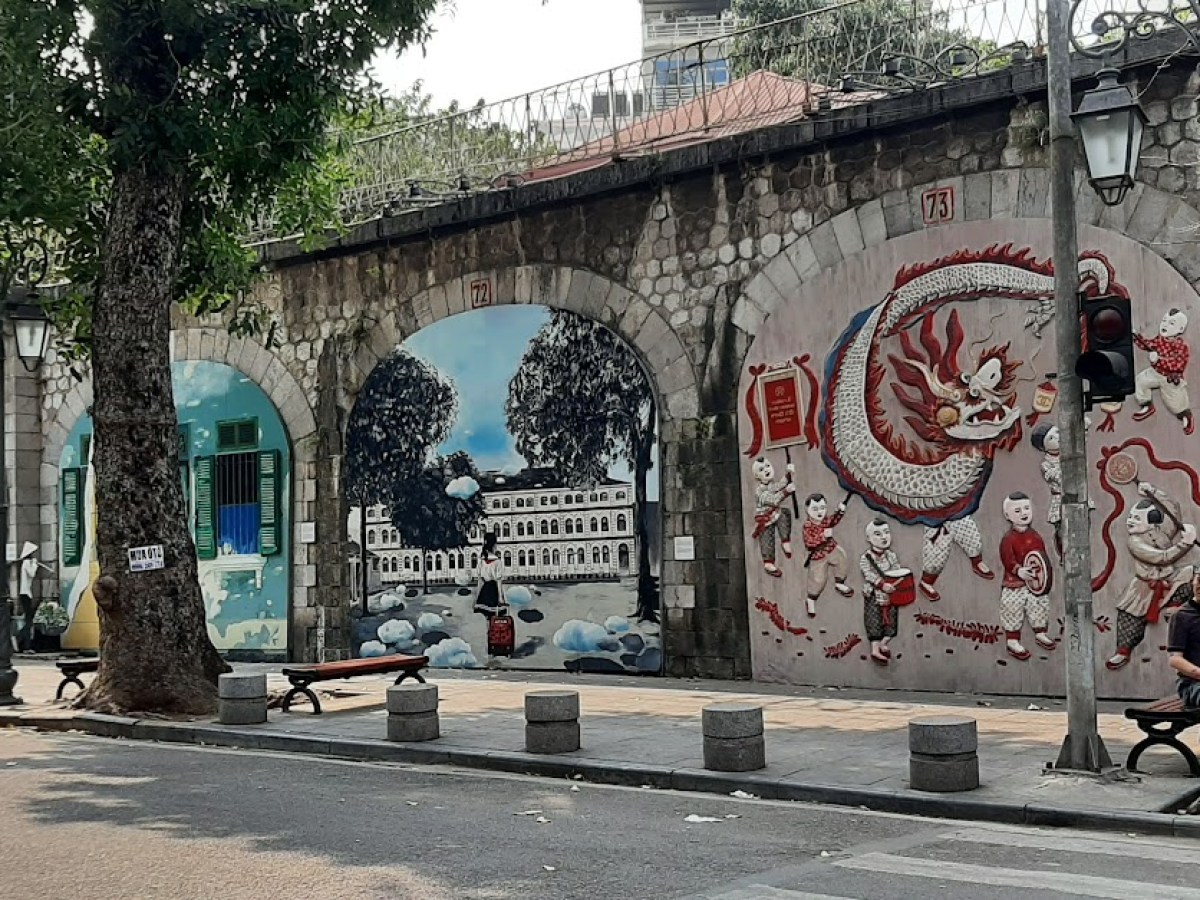 a building with graffiti on the side of a road