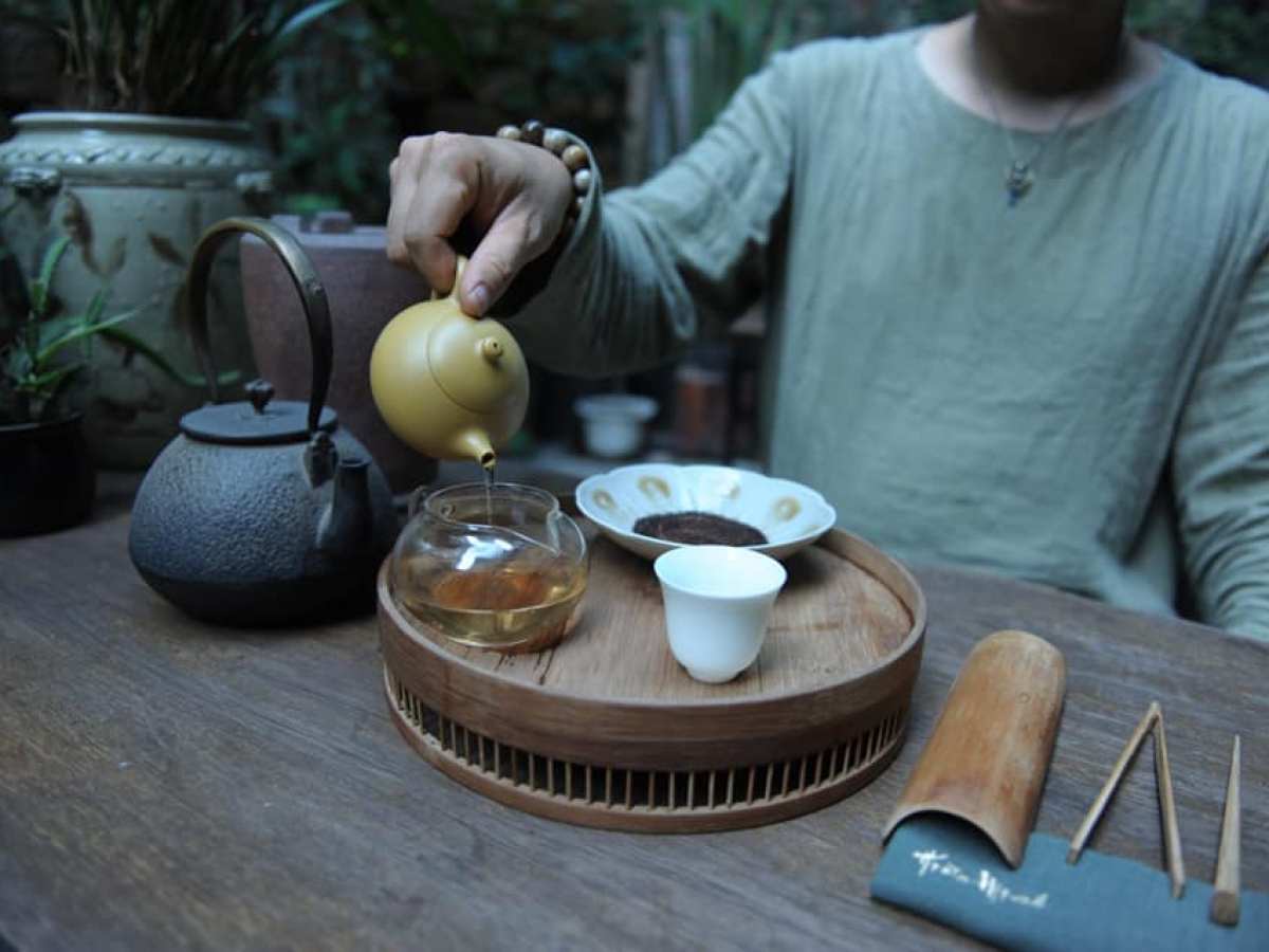 a man standing on top of a wooden table