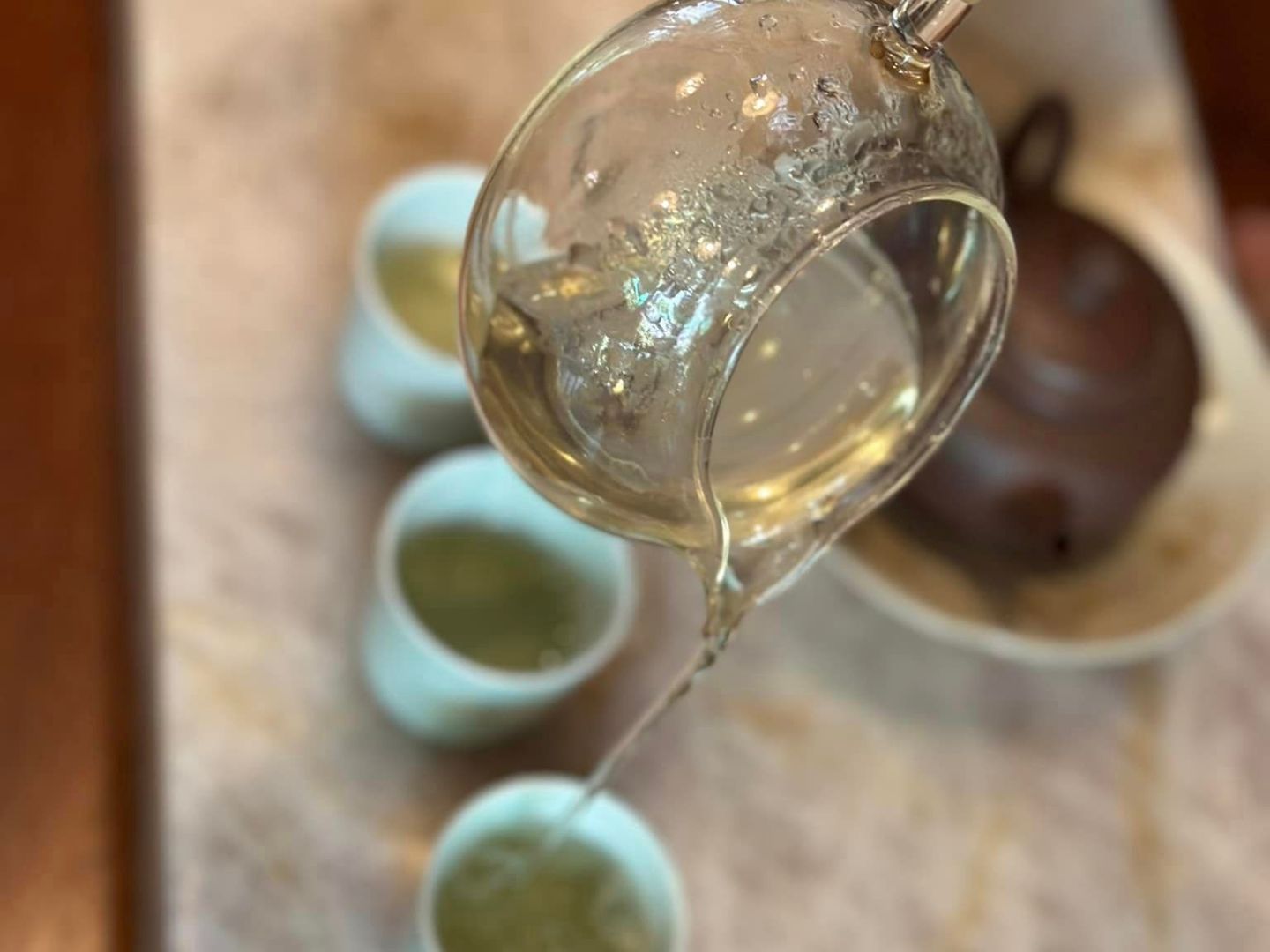 a hand holding a glass of wine