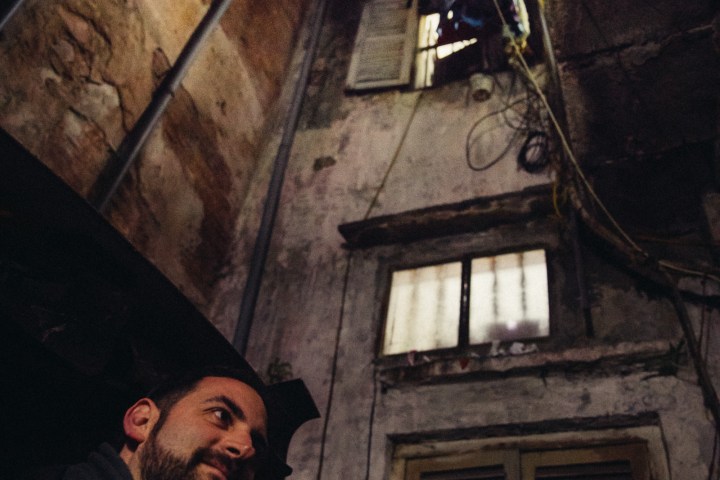 a man standing next to a fireplace