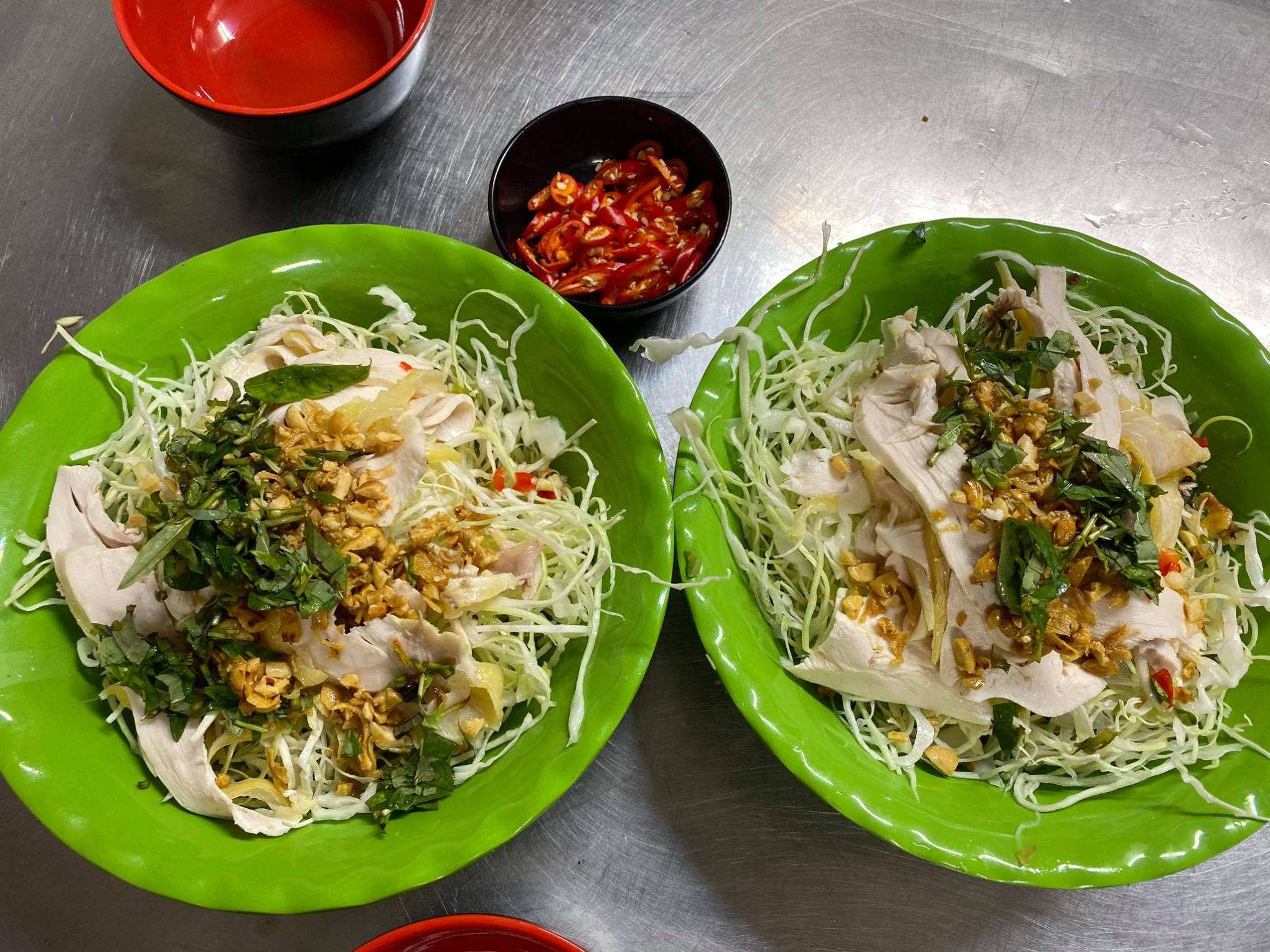 a plate of food with a green bowl on a table