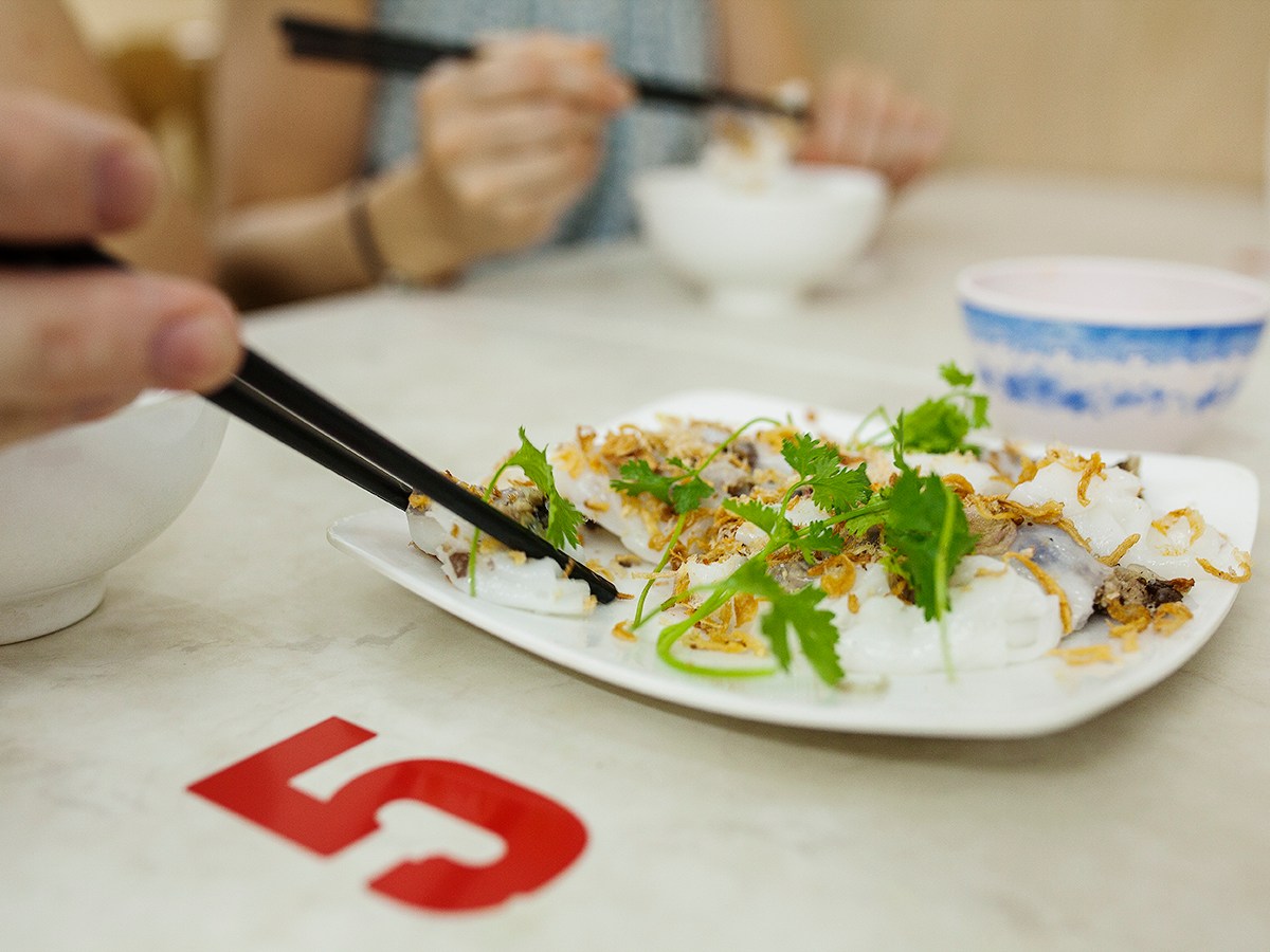 a person sitting at a table with a plate of food