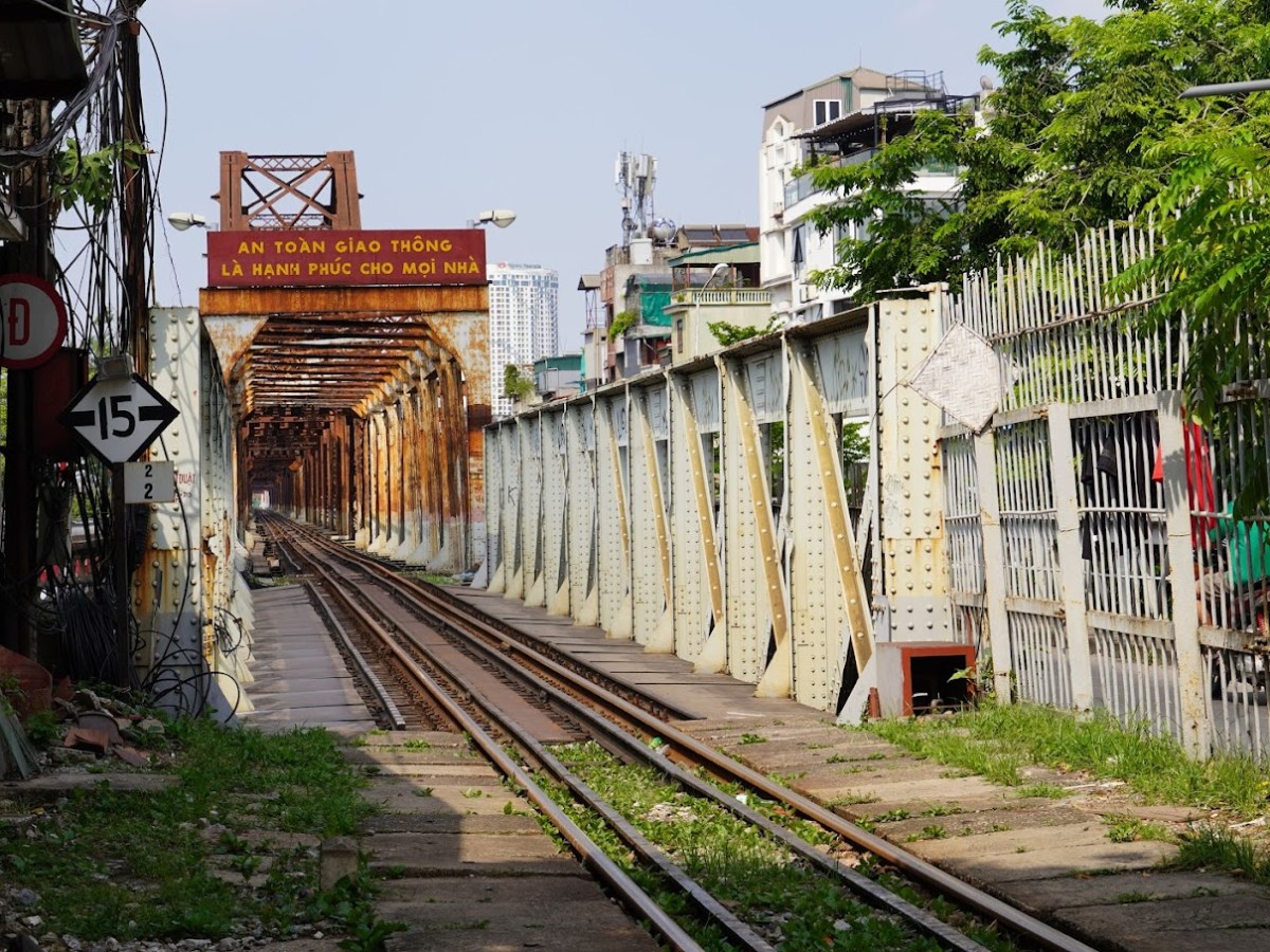 a train traveling down train tracks next to a fence