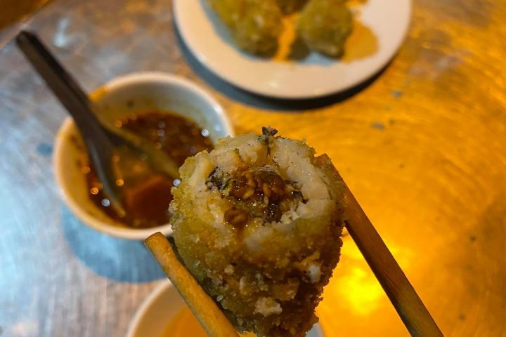 a plate of food and a spoon on a table