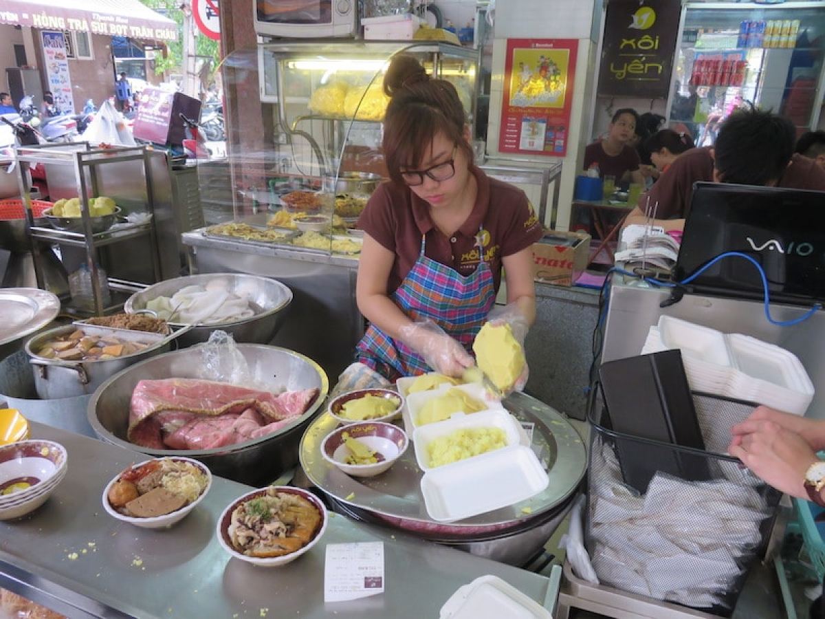 a woman sitting at a table with a plate of food