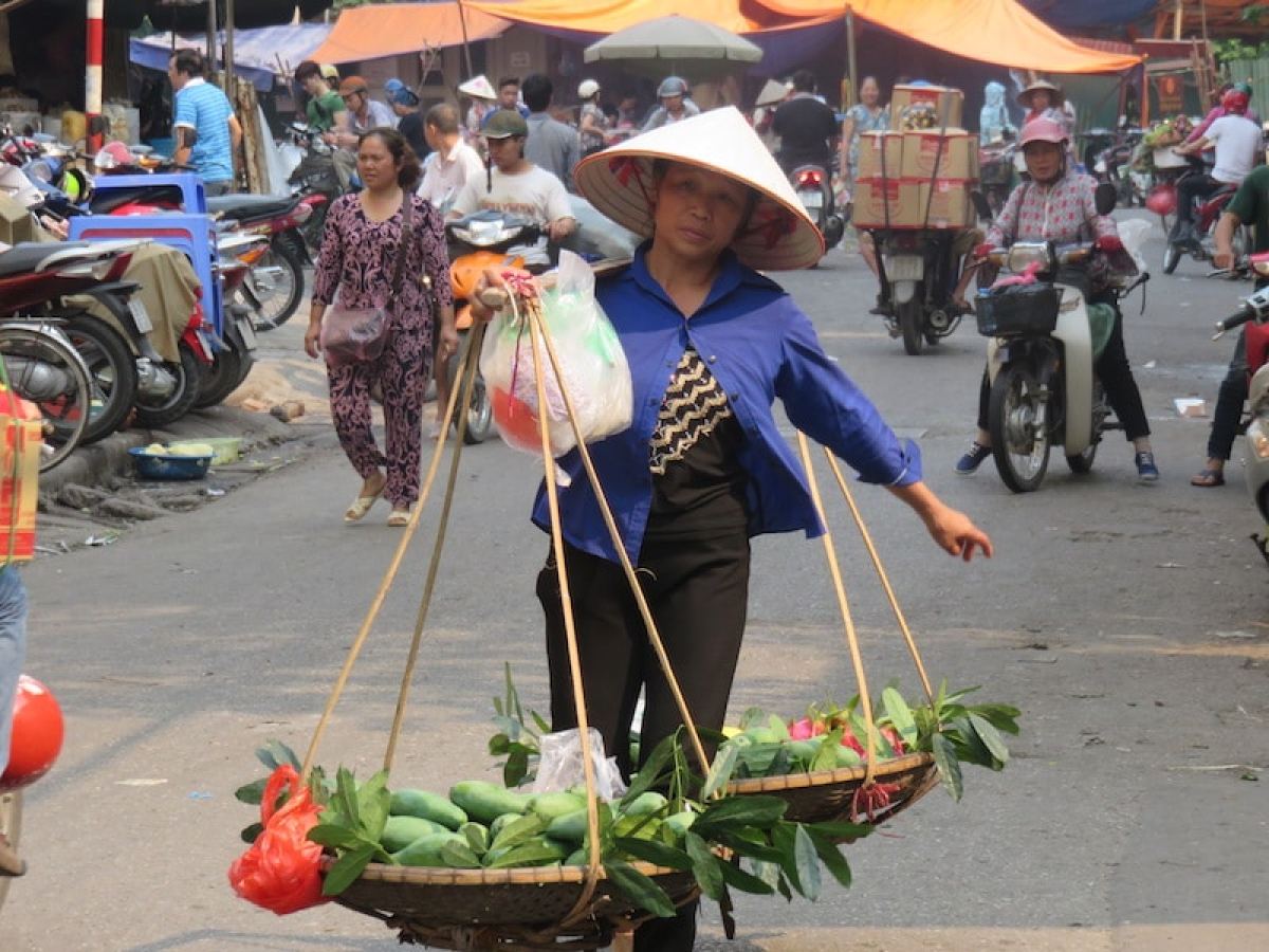 a group of people walking down a street holding an umbrella