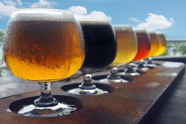 a glass of wine sitting on top of a wooden table