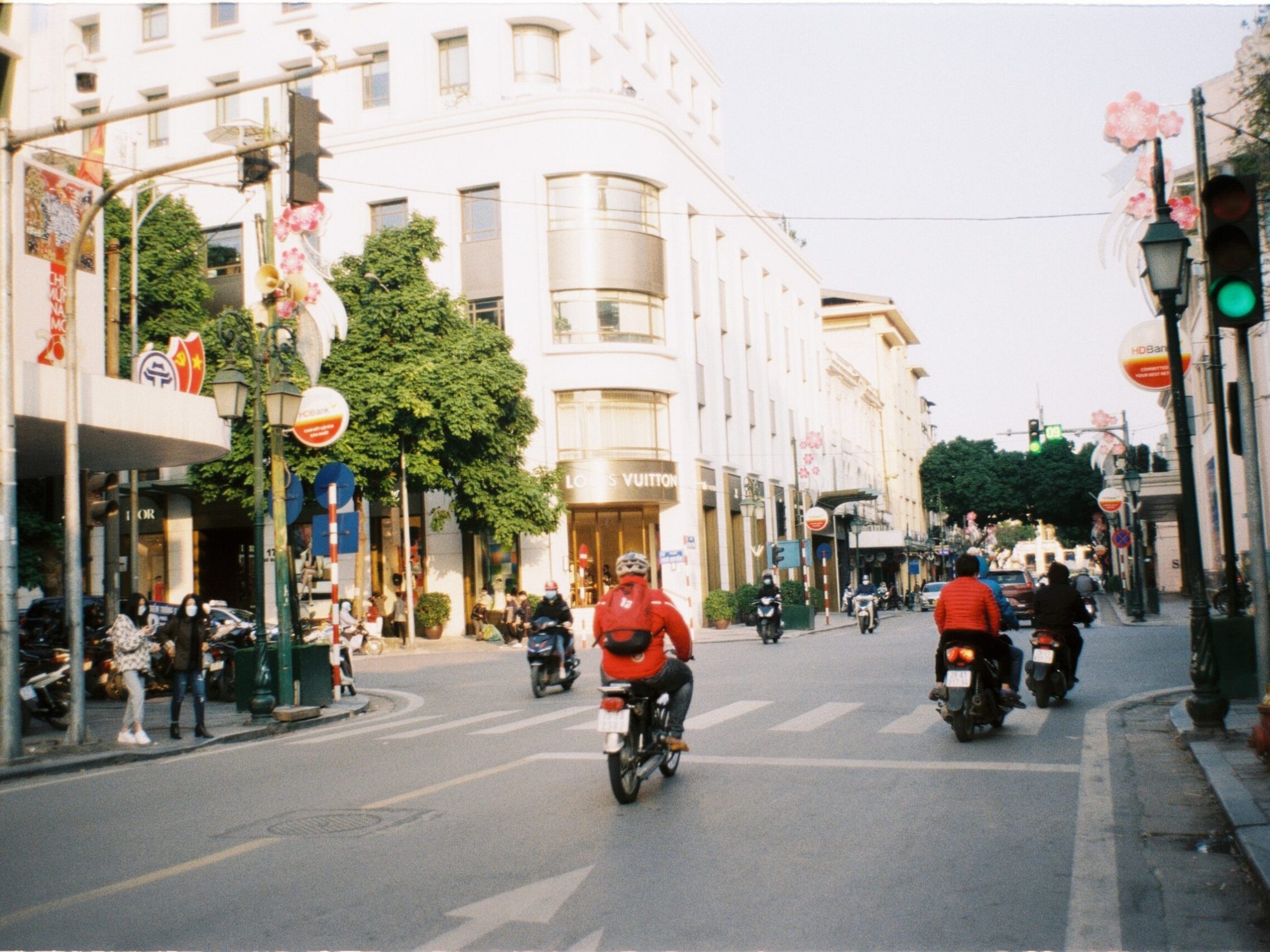 a group of people riding motorcycles on a city street