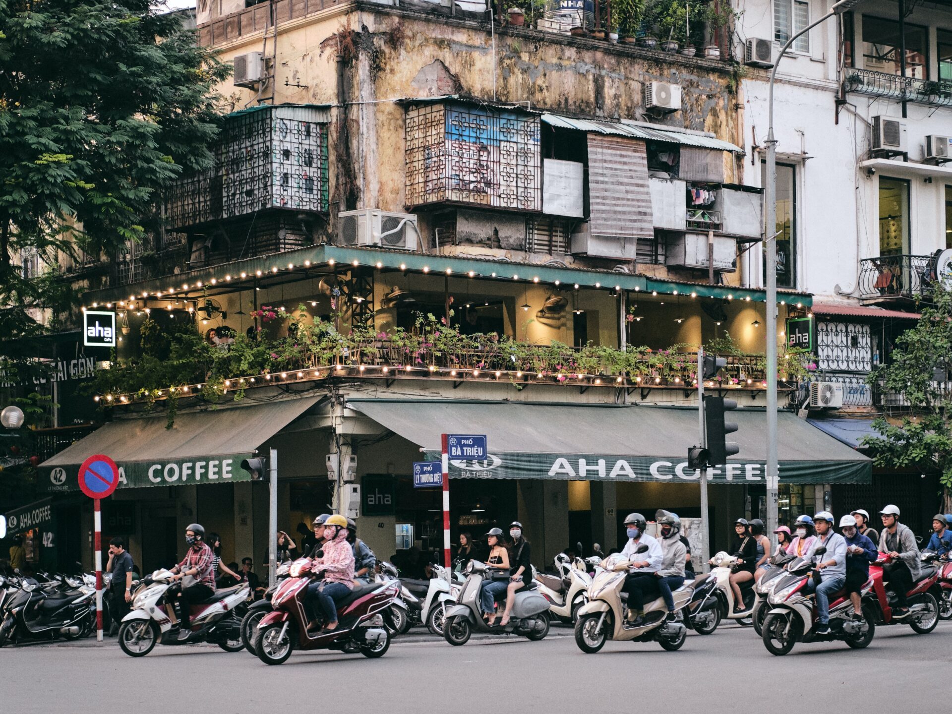 a group of people riding a motorcycle on a city street