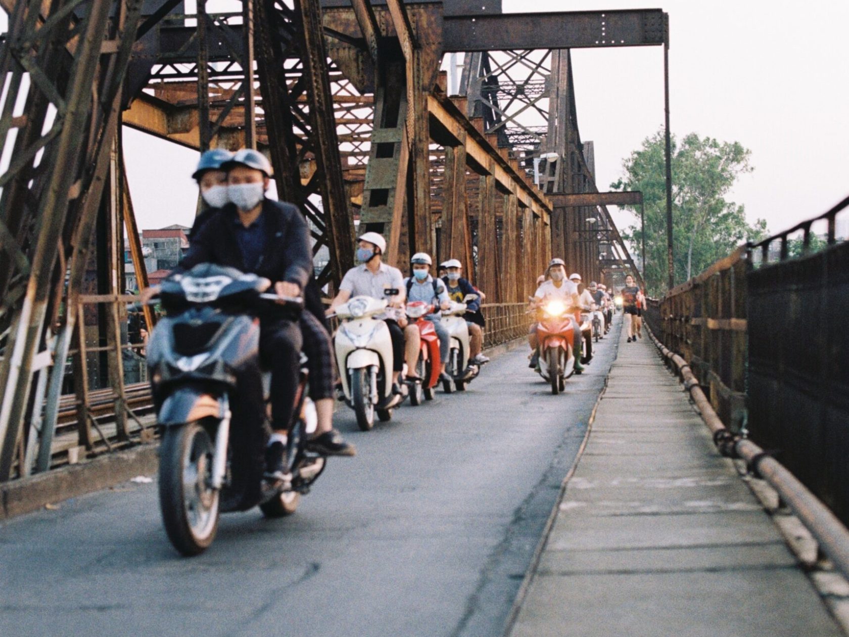a group of people walking on a bridge