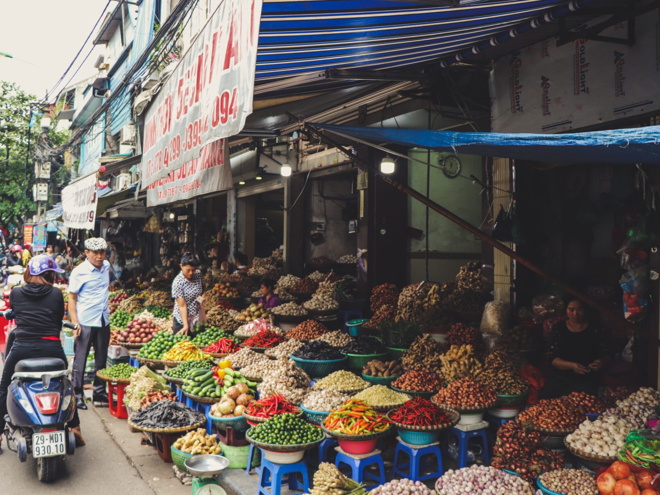 a group of people at a fruit stand