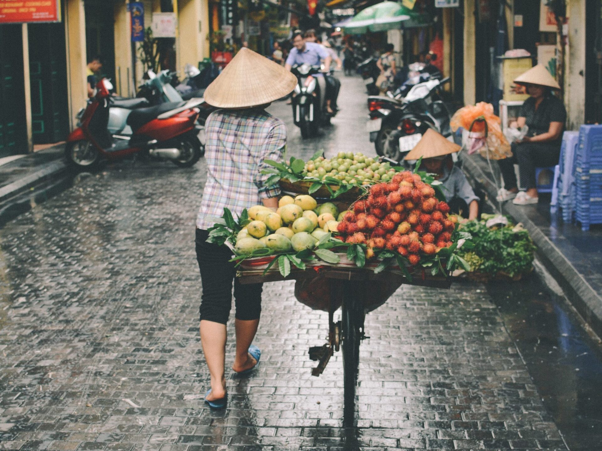 a street filled with lots of fruit and vegetable stand