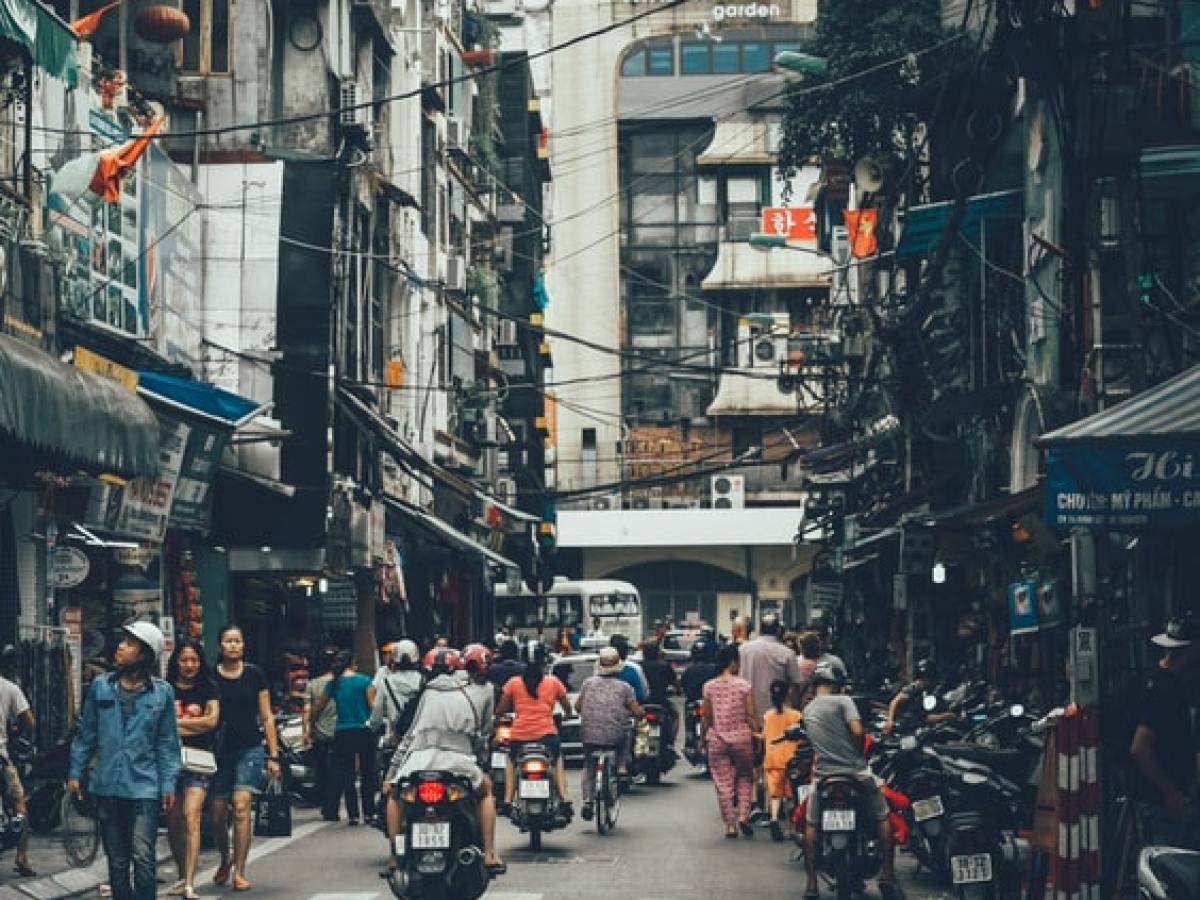 a group of people walking down a busy city street