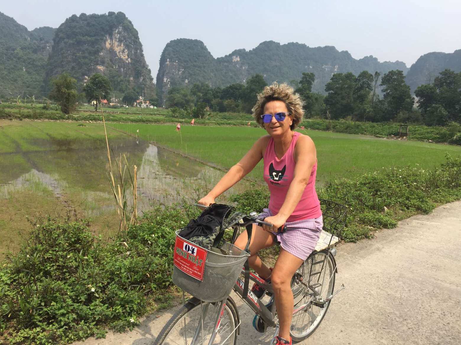 a person riding a bike down a dirt road