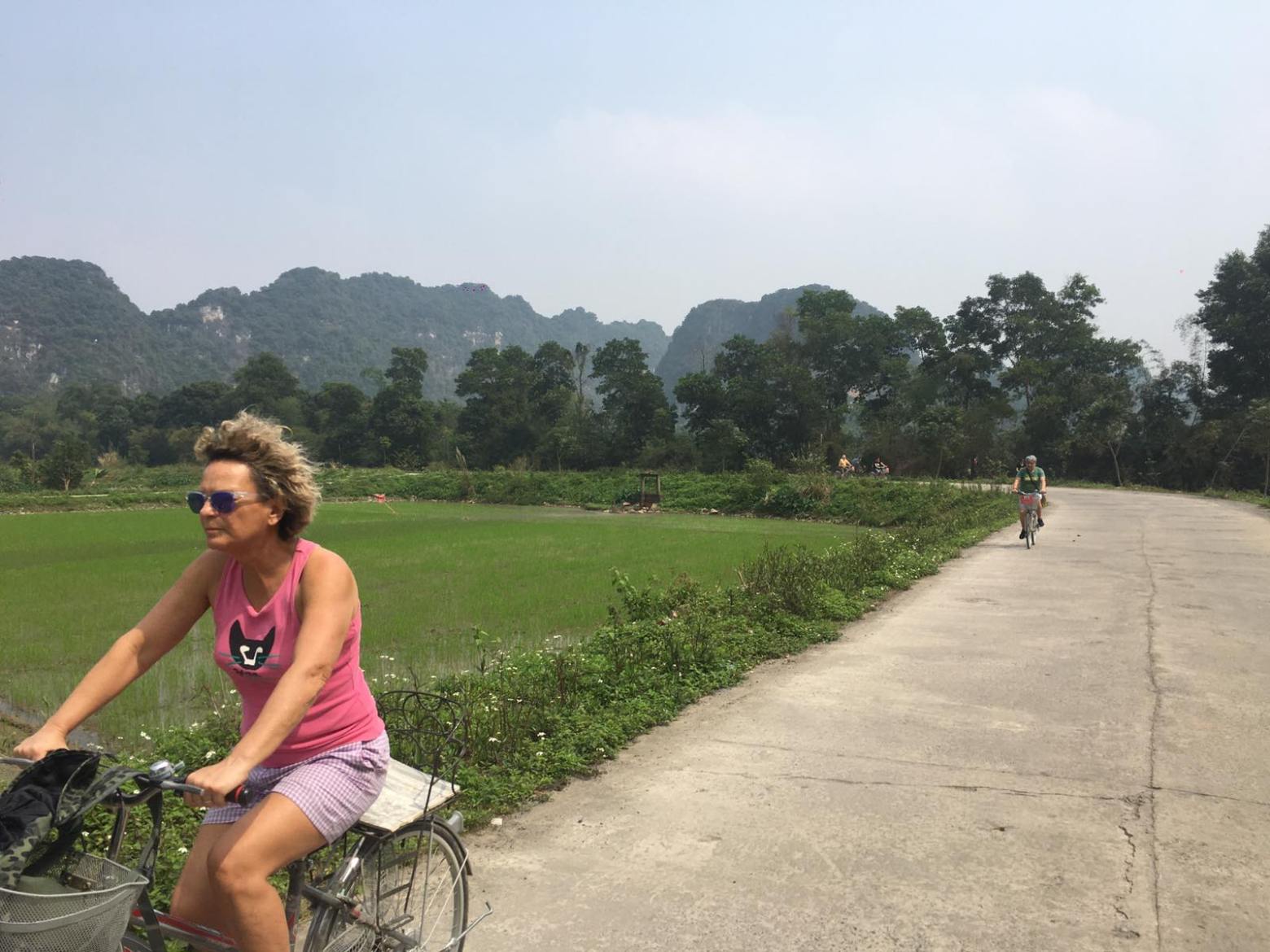 a person riding a bike down a dirt road