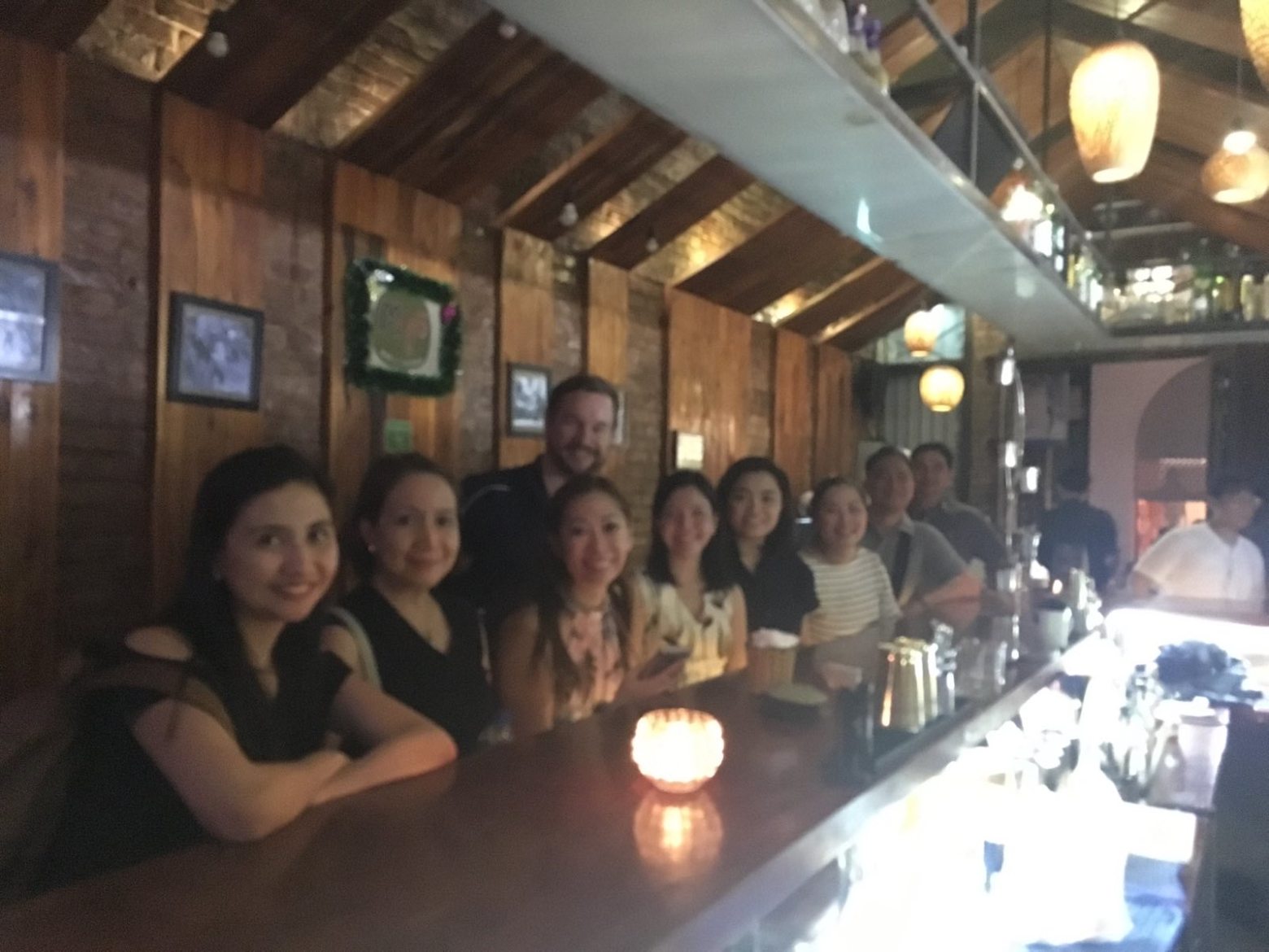 a group of people sitting at a table in a restaurant