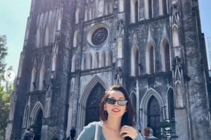 a woman standing in front of a church