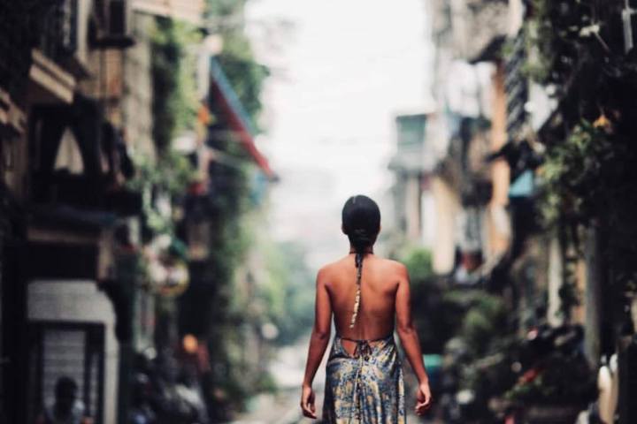 a man riding a skateboard down a sidewalk