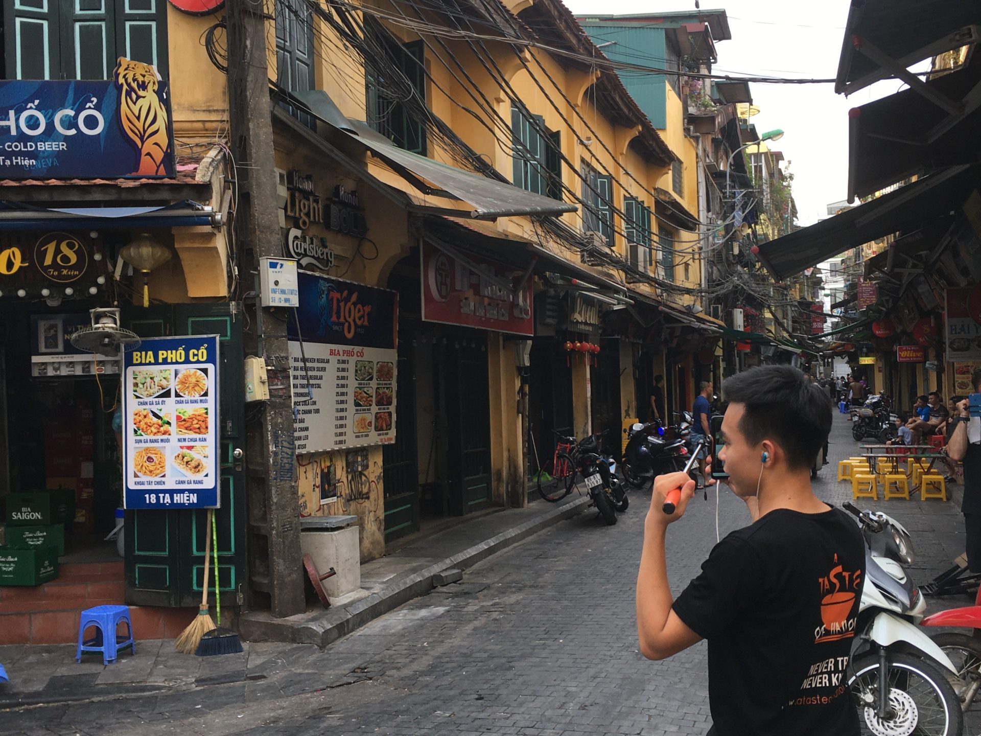 a person walking down the street talking on a cell phone