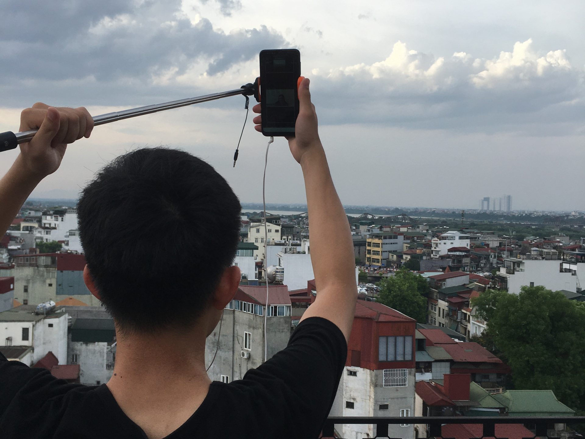 a man standing in front of a cloudy sky
