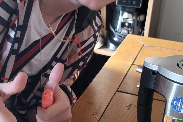 a person sitting at a table with a cake on a plate