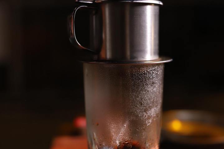 a close up of a coffee cup sitting on top of a wooden table